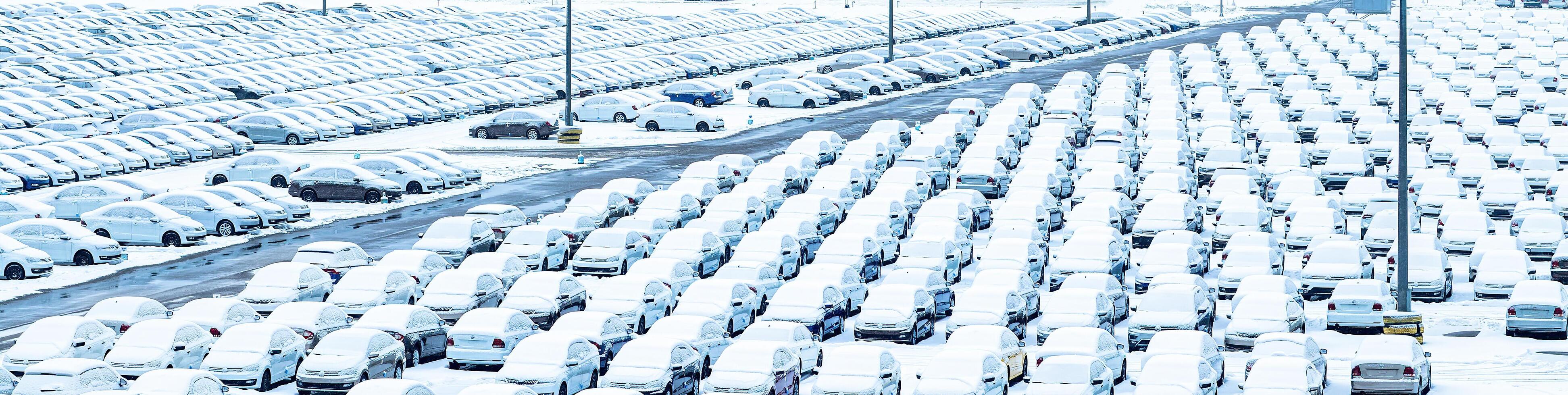 Volkswagen, Russia, Kaluga - NOVEMBER 11, 2022 New cars covered with a snow and parked in a distribution center, a car factory. photo