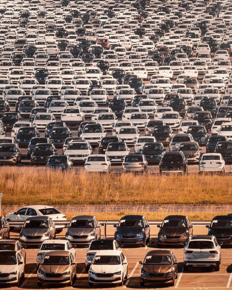 Volkswagen, Russia, Kaluga - JULY 14, 2022 New cars parked at distribution center automobile factory at night with lights. photo
