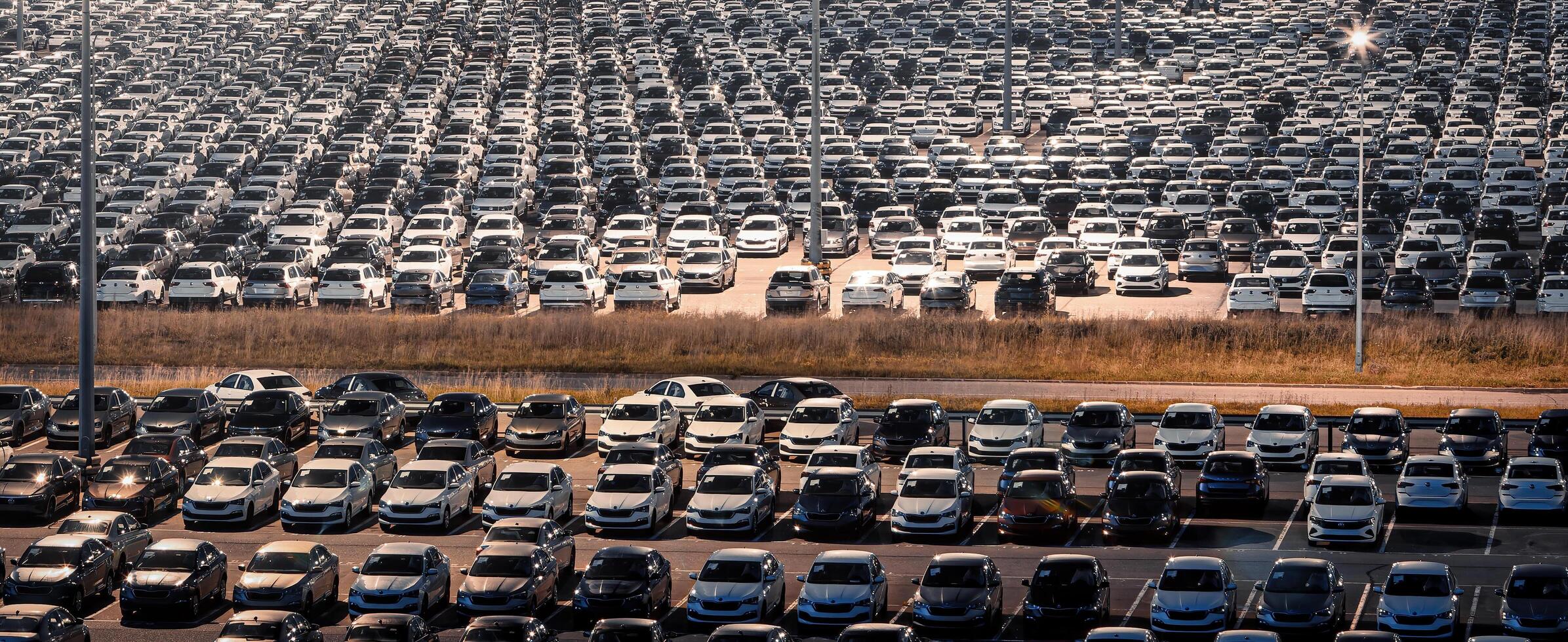 Volkswagen, Russia, Kaluga - JULY 14, 2022 New cars parked at distribution center automobile factory at night with lights. photo