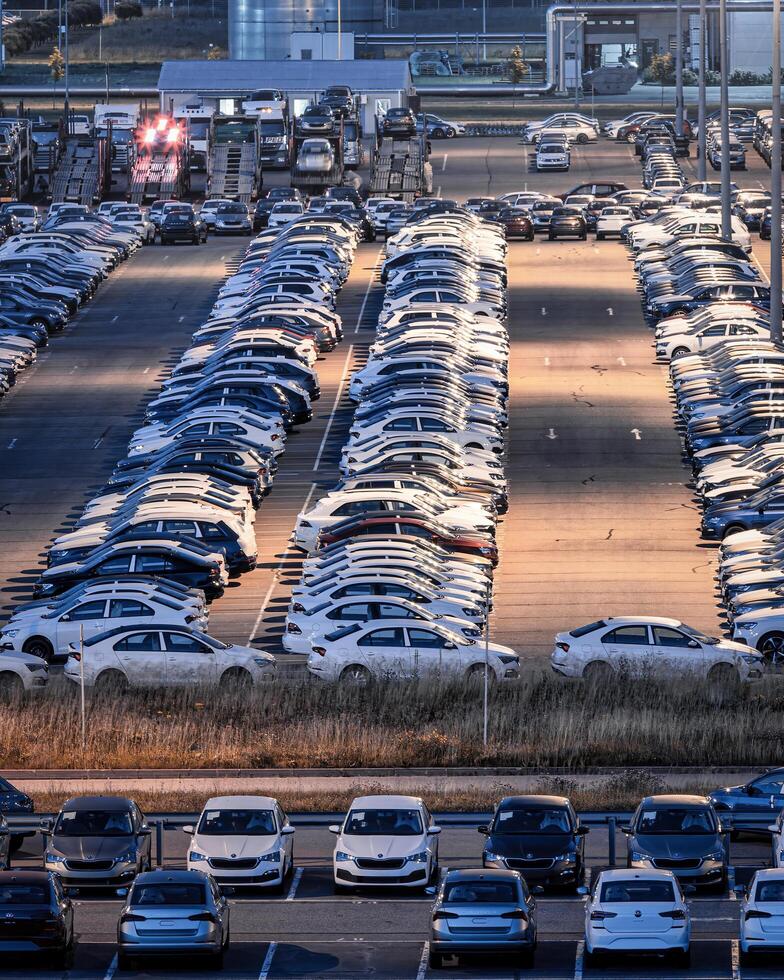 Volkswagen, Russia, Kaluga - JULY 14, 2022 New cars parked at distribution center automobile factory at night with lights. photo