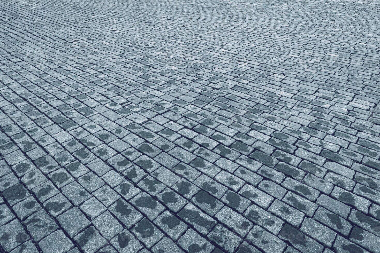 Top view on paving stone road. Old pavement of granite texture. photo