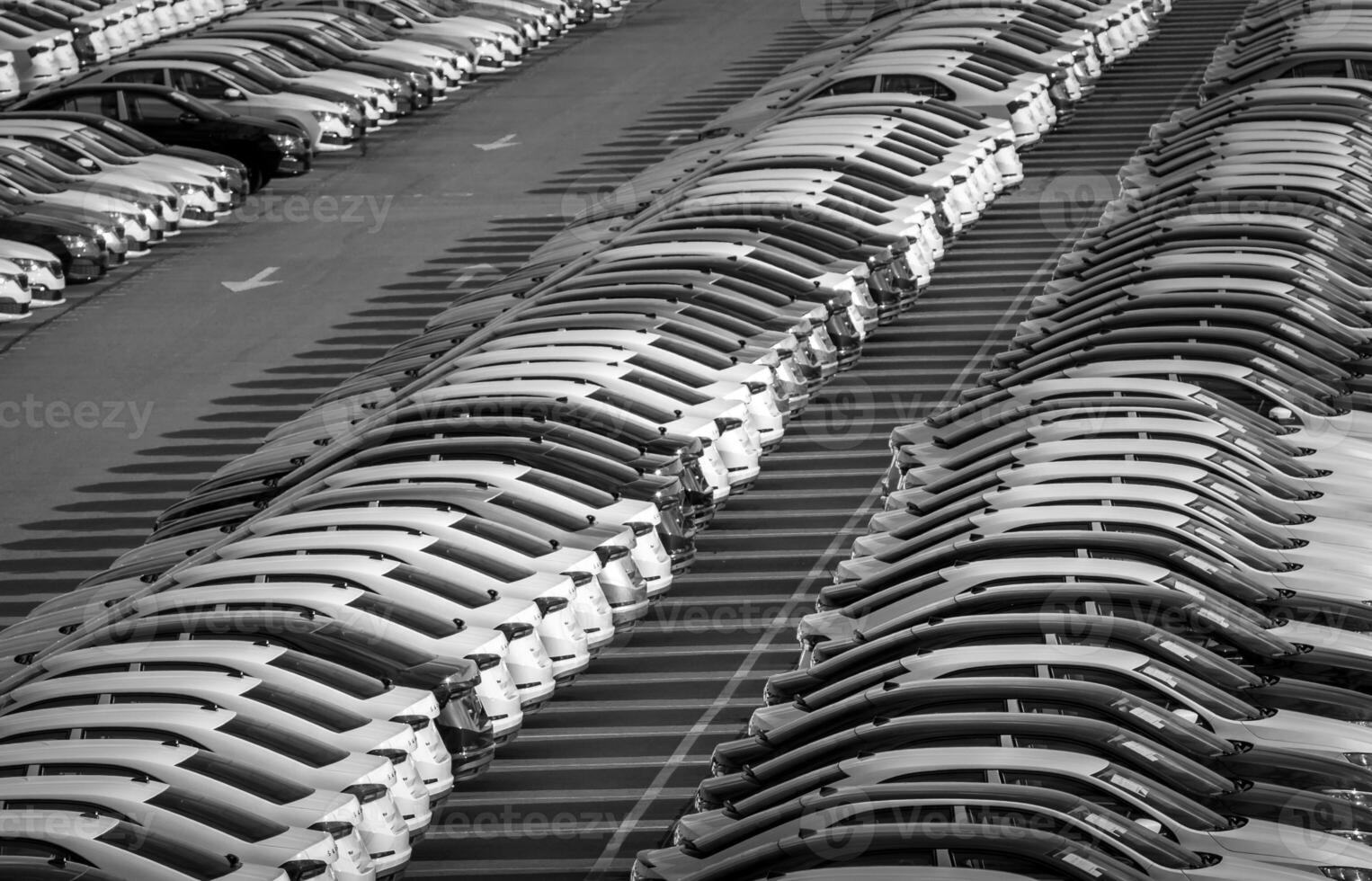 Volkswagen Group Rus, Russia, Kaluga - MAY 24, 2020 Rows of a new cars parked in a distribution center on a day in the spring, a car factory. Parking in the open air. Black and white photo. photo