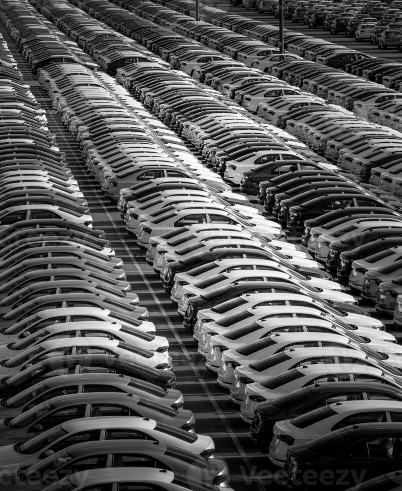 Volkswagen Group Rus, Russia, Kaluga - MAY 24, 2020 Rows of a new cars parked in a distribution center on a day in the spring, a car factory. Parking in the open air. Black and white photo. photo