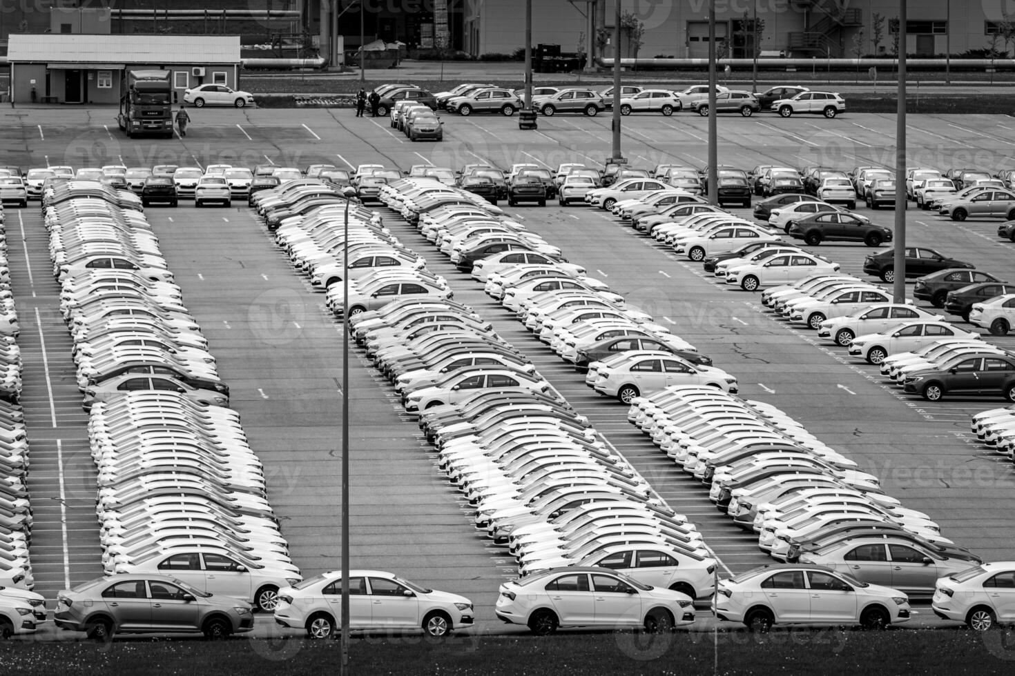 Volkswagen Group Rus, Russia, Kaluga - MAY 24, 2020 Rows of a new cars parked in a distribution center on a day in the spring, a car factory. Parking in the open air. Black and white photo. photo