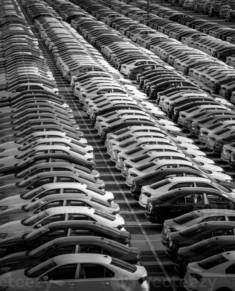 Volkswagen Group Rus, Russia, Kaluga - MAY 24, 2020 Rows of a new cars parked in a distribution center on a day in the spring, a car factory. Parking in the open air. Black and white photo. photo