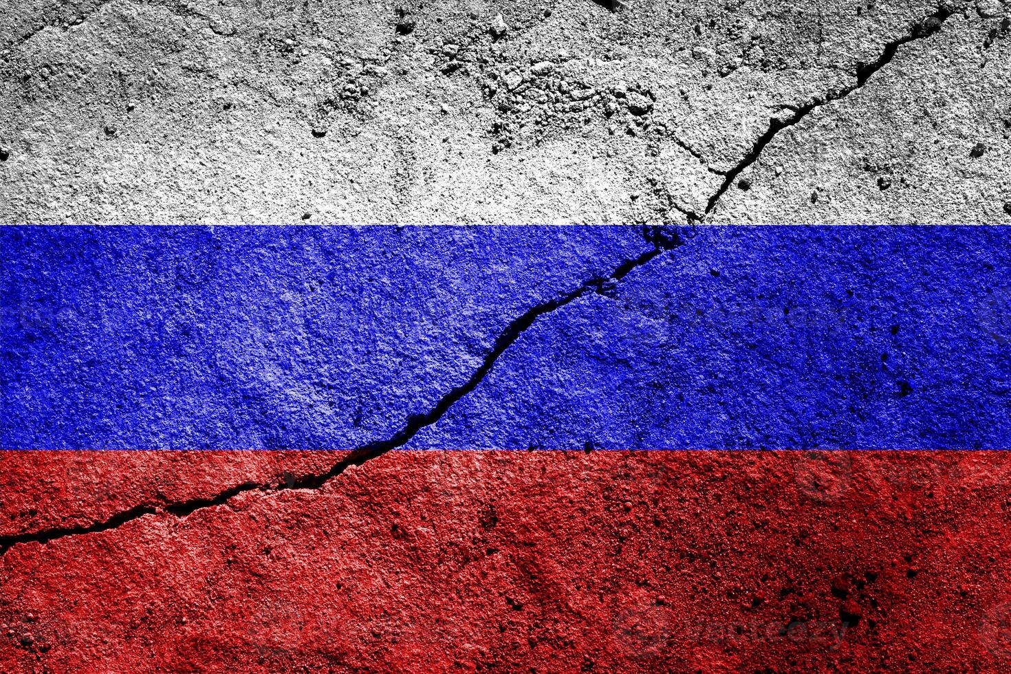 Russian Federation flag on cracked concrete wall. The concept of crisis, default, economic collapse, pandemic, conflict, terrorism or other problems in the country. Abstract disaster symbol. photo