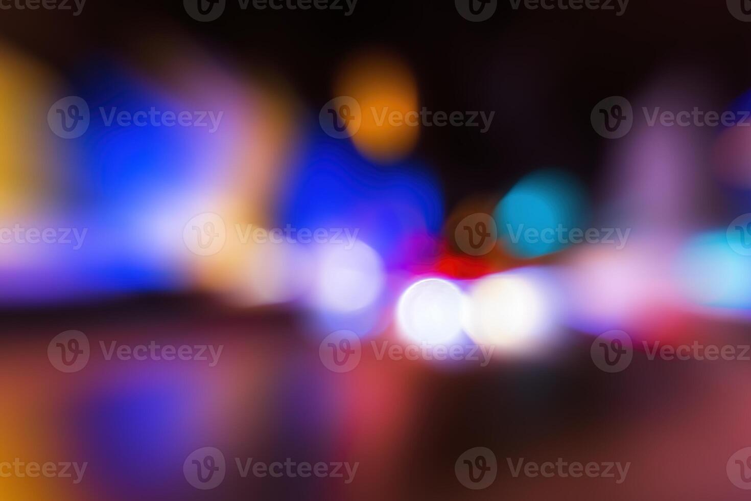 Blurred lights of headlights of cars and lanterns in the night city. Abstract bokeh. photo