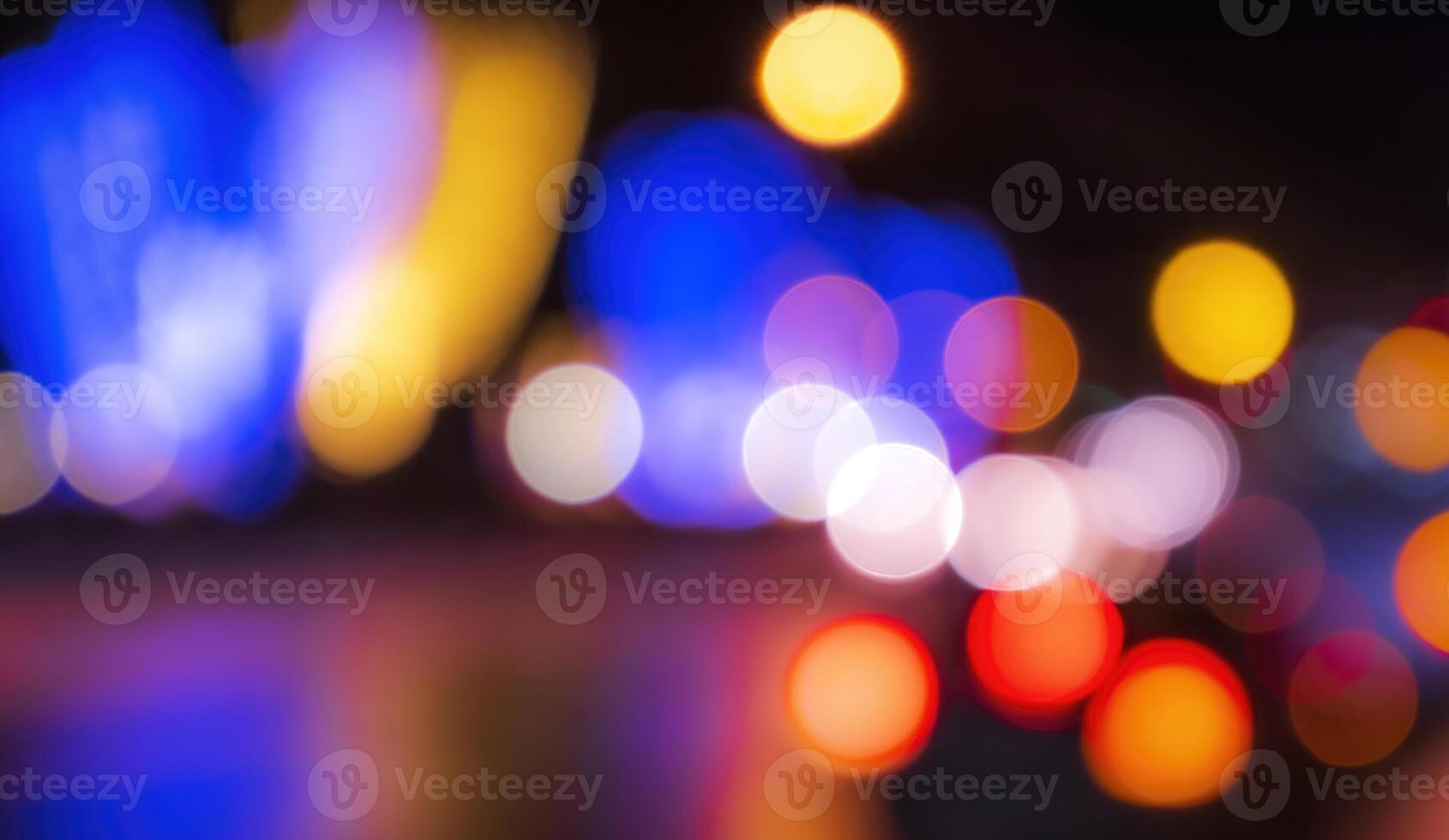 Blurred lights of headlights of cars and lanterns in the night city. Abstract bokeh. photo