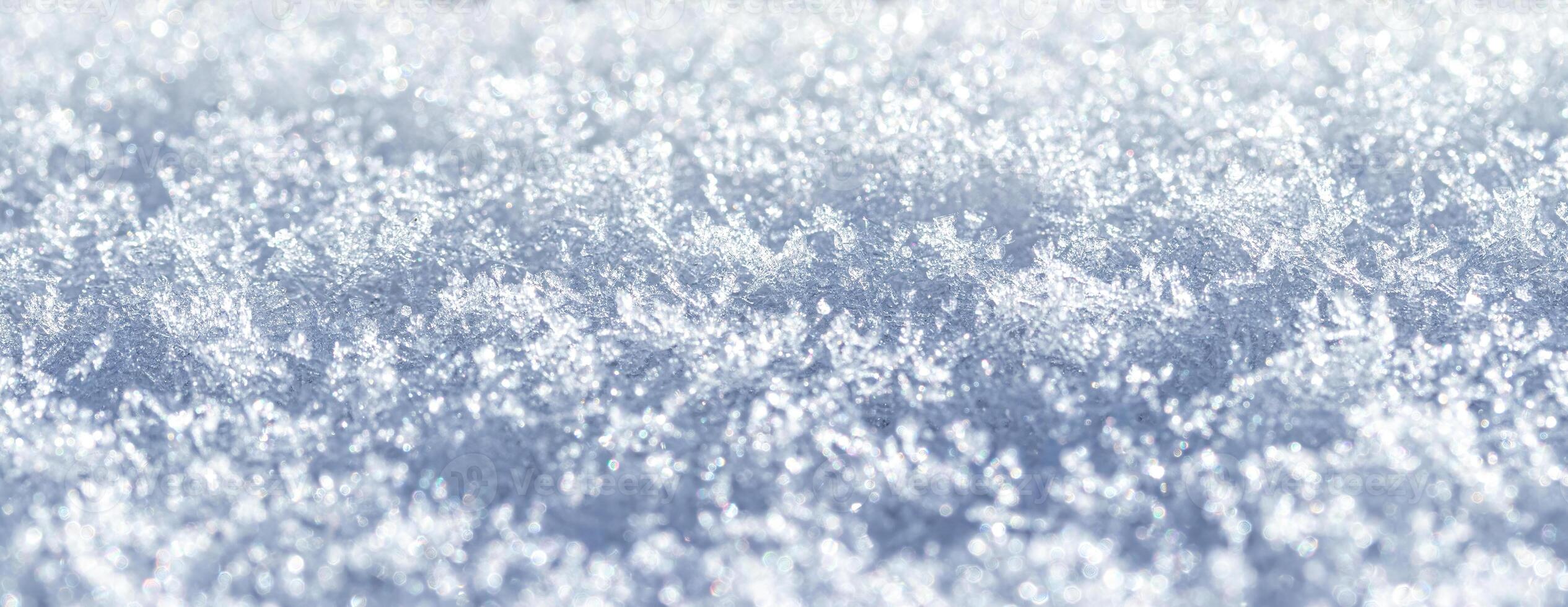 Snow crystals illuminated by sunlight. Winter background. photo