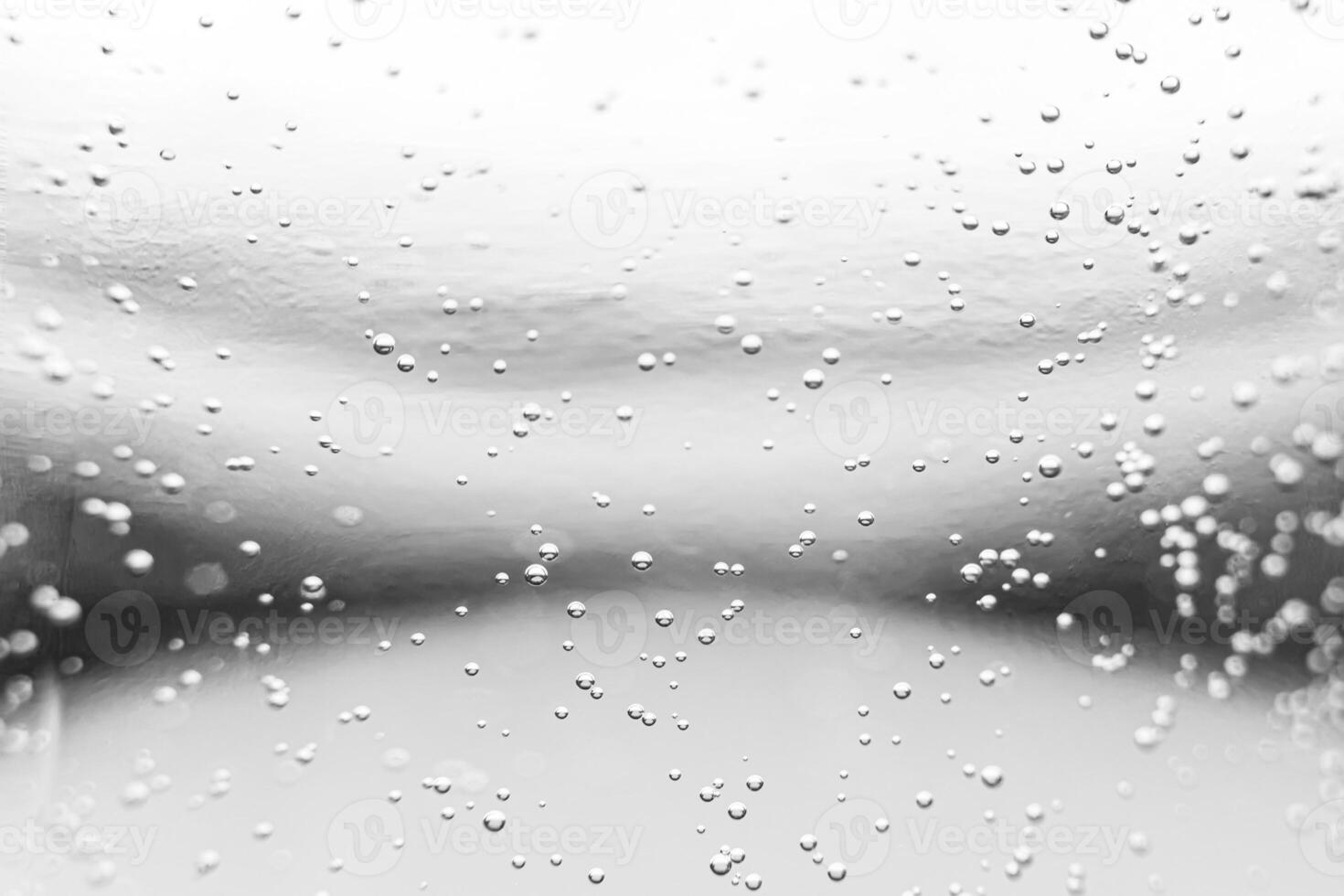 Monochrome background with air bubbles in the liquid. Carbonated drinks. Abstract backdrop. photo