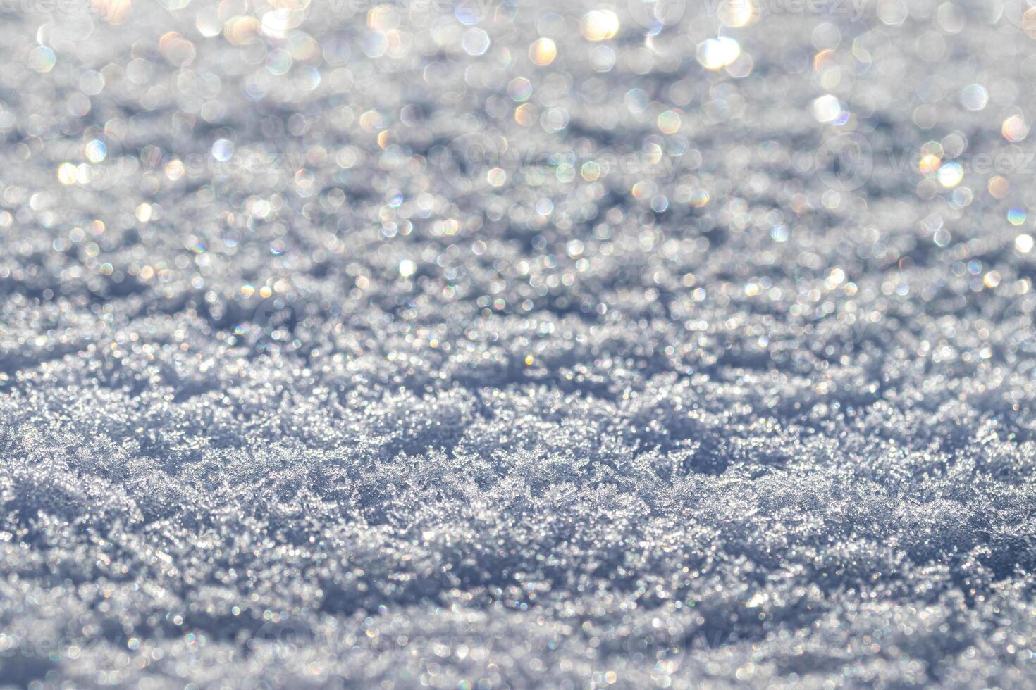 Snow crystals illuminated by sunlight. Winter background. photo