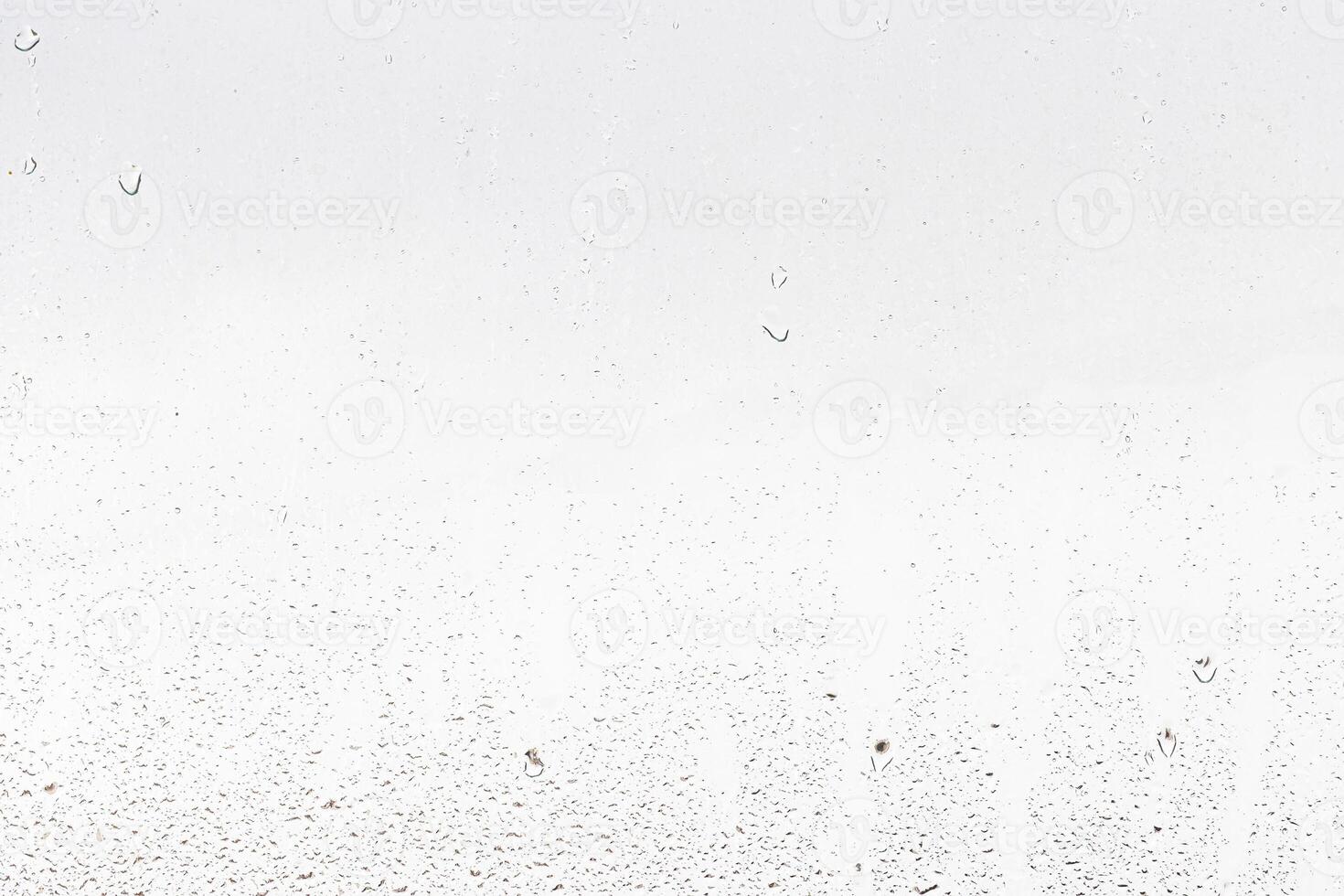 Rain drops on window glasses surface with gray sky background . Natural backdrop of raindrops. Abstract overlay for design. The concept of rainy weather. photo