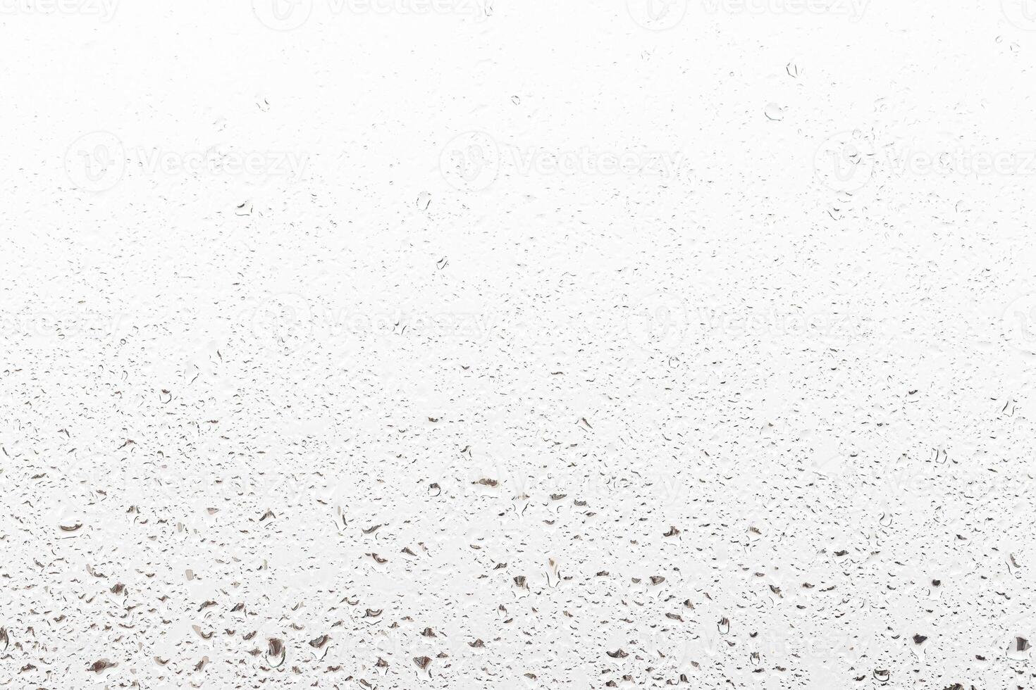 Rain drops on window glasses surface with gray sky background . Natural backdrop of raindrops. Abstract overlay for design. The concept of rainy weather. photo