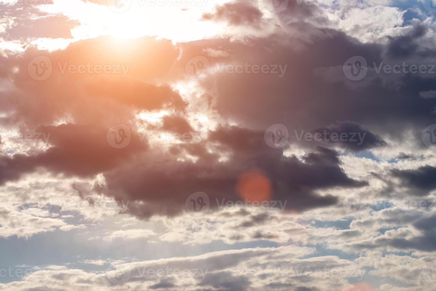 Sun rays breaking through cumulus clouds. The concept of divine light, a glimmer of hope or overcoming difficulties. Spiritual religious background. photo