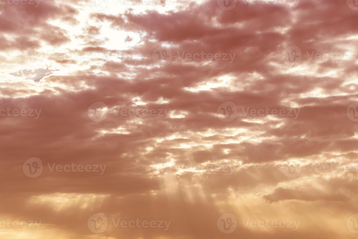 Sun rays breaking through cumulus clouds. The concept of divine light, a glimmer of hope or overcoming difficulties. Spiritual religious background. photo