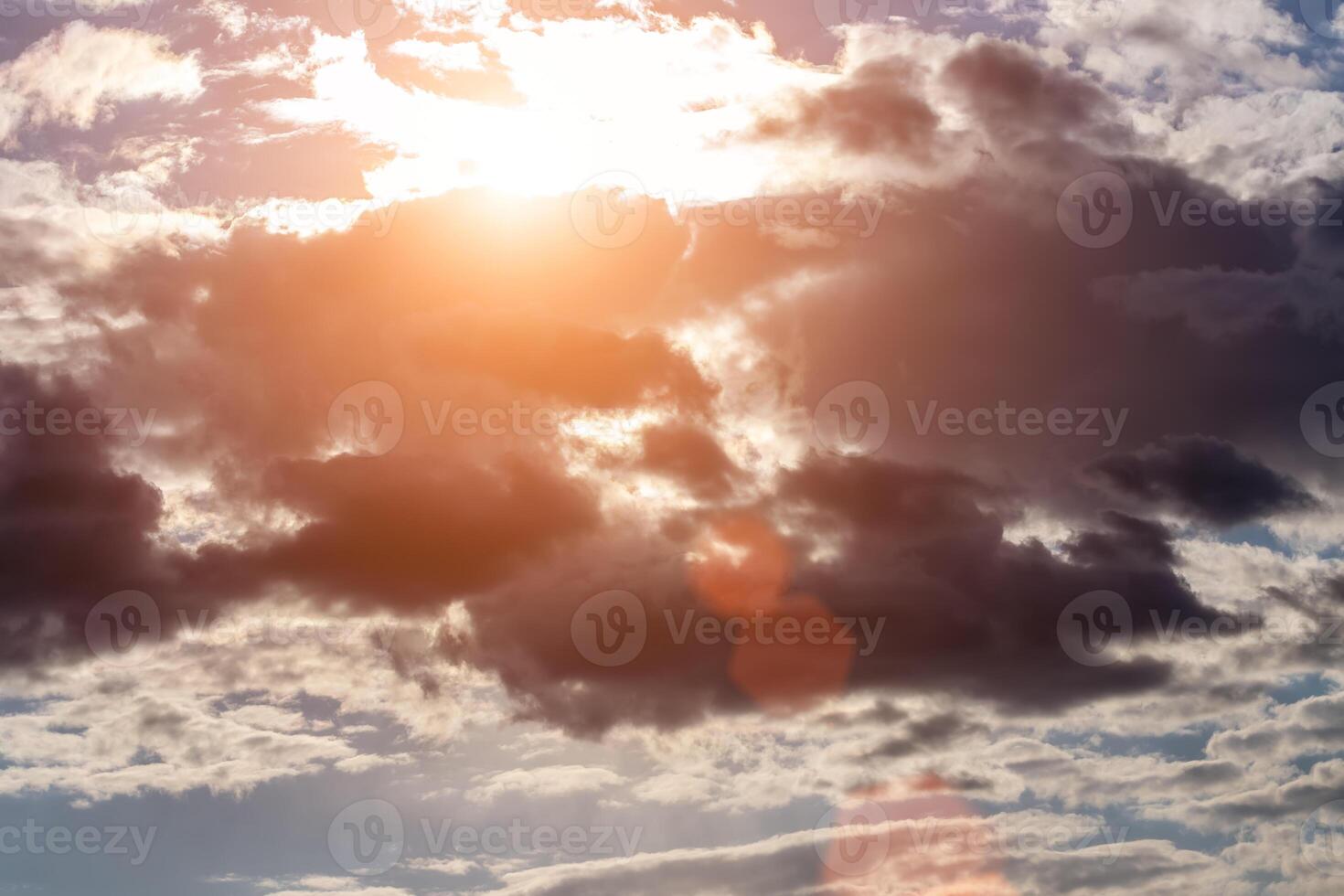 Sun rays breaking through cumulus clouds. The concept of divine light, a glimmer of hope or overcoming difficulties. Spiritual religious background. photo