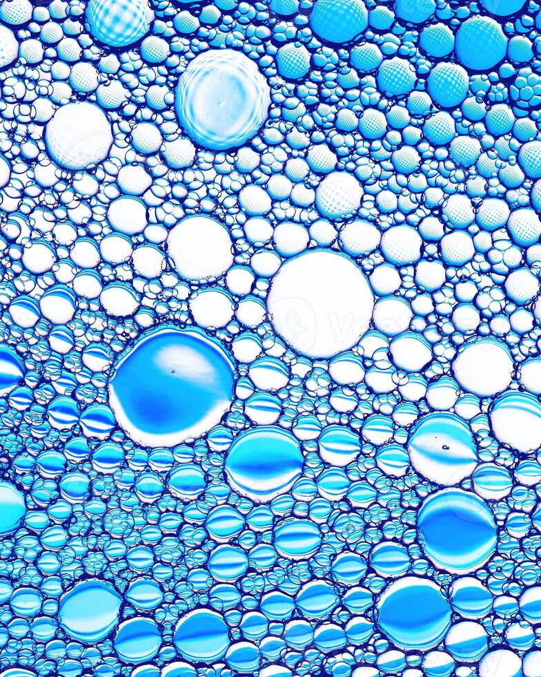 Top view on colorful drops of oil on the water. Circles and ovals. photo