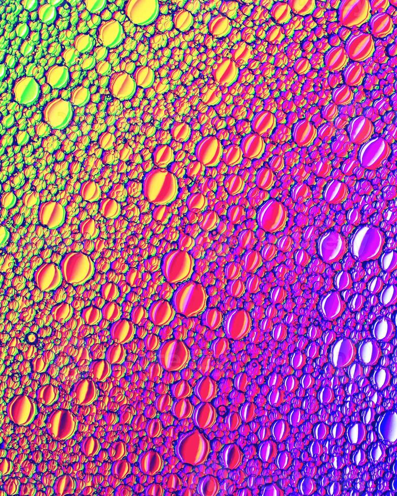 Top view on colorful drops of oil on the water. Circles and ovals. photo