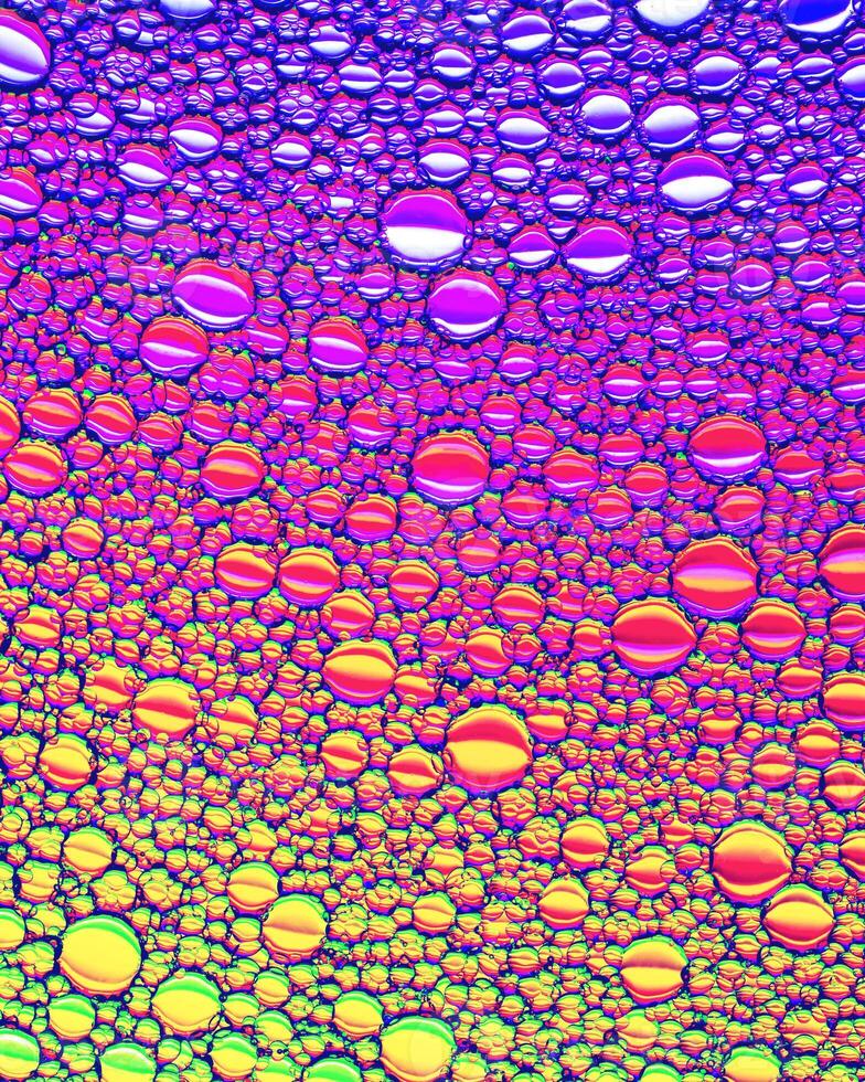 Top view on colorful drops of oil on the water. Circles and ovals. photo