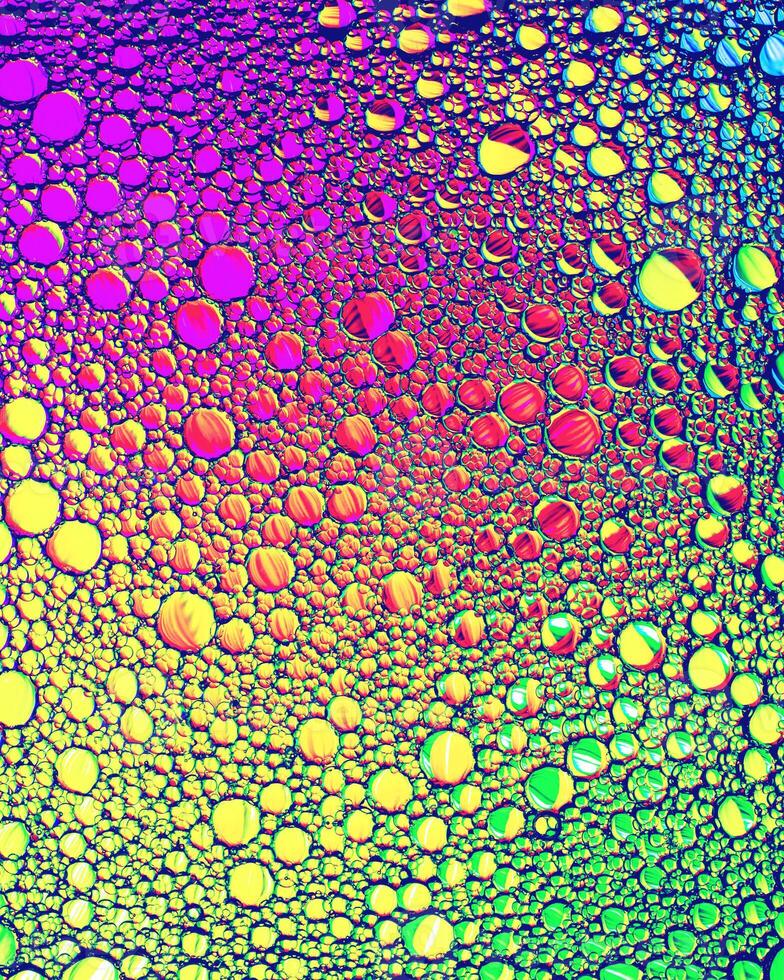 Top view on colorful drops of oil on the water. Circles and ovals. photo