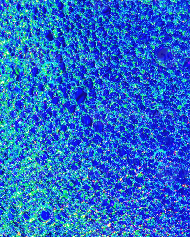 Top view on colorful drops of oil on the water. Circles and ovals. photo