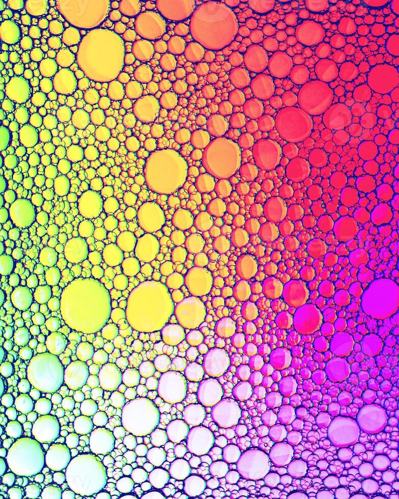 Top view on colorful drops of oil on the water. Circles and ovals. photo
