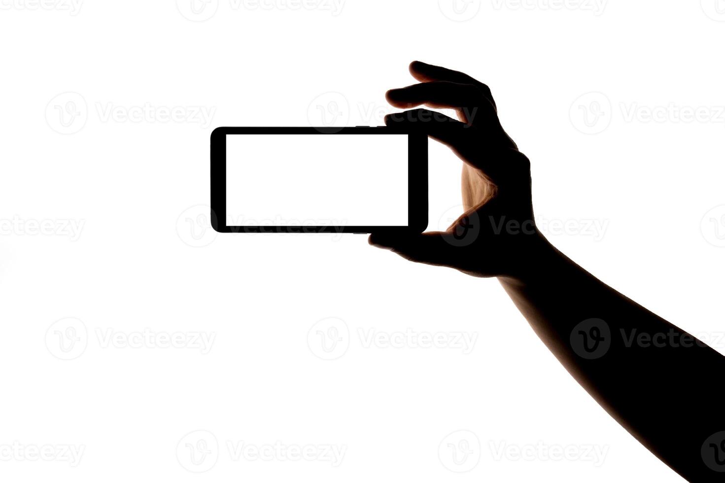 Silhouette of hand with smartphone taking picture isolated on white background. Screen with copy space. Blank for design. photo