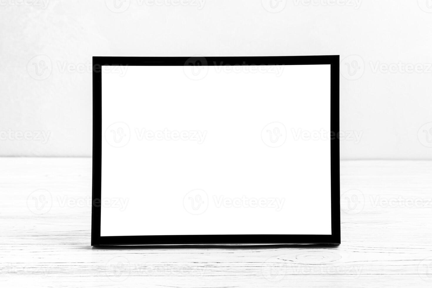 White wooden floor over concrete or decorative plaster wall and black photo frame with copy space for a text background. Mock up.