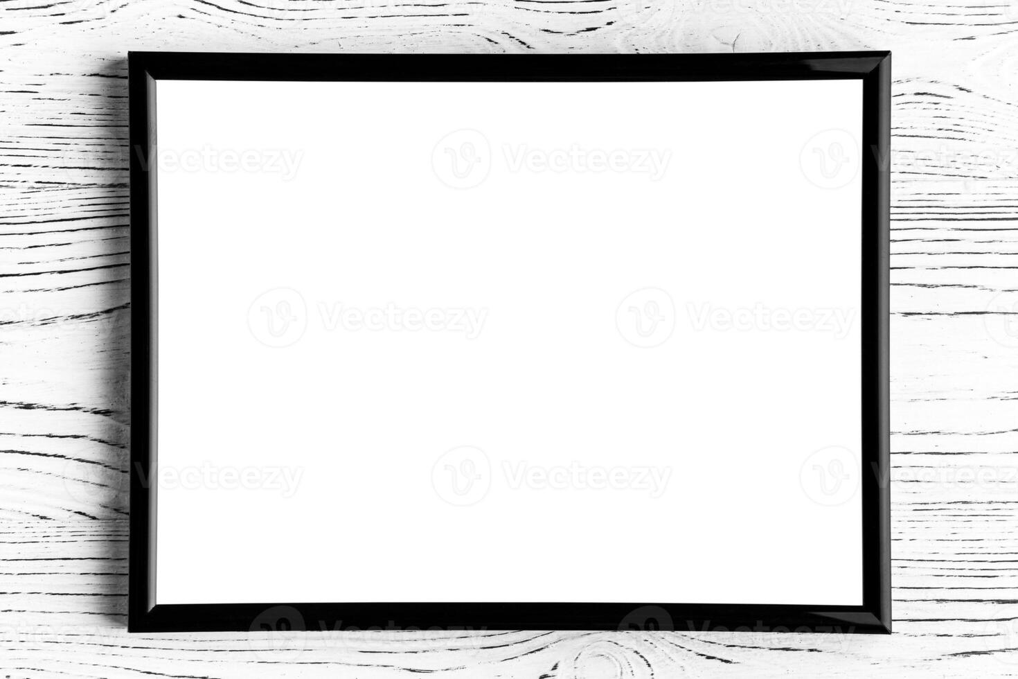 Black photo frame on a white wooden table. Abstract background for design. Art stylized baner or mock up with copy space.