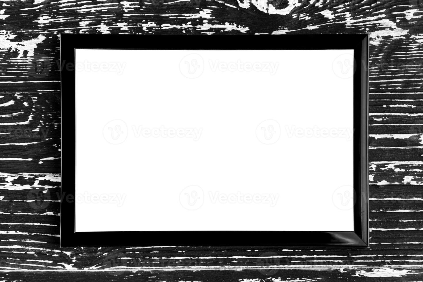 Black photo frame on a wooden table. Abstract background for design. Art stylized baner or mock up with copy space.