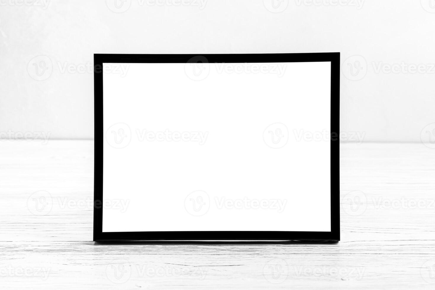White wooden floor over concrete or decorative plaster wall and black photo frame with copy space for a text background. Mock up.