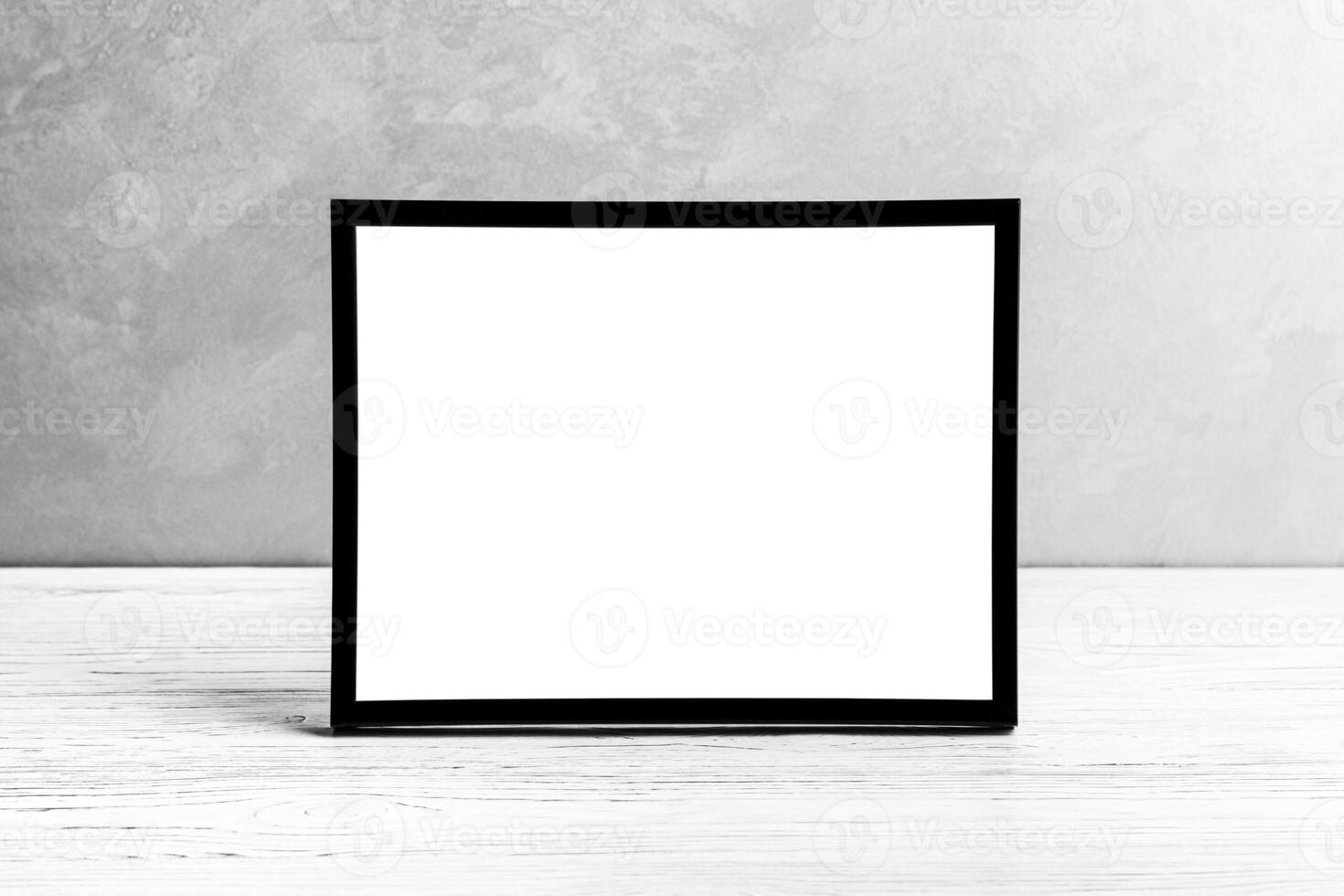 White wooden floor over concrete or decorative plaster wall and black photo frame with copy space for a text background. Mock up.