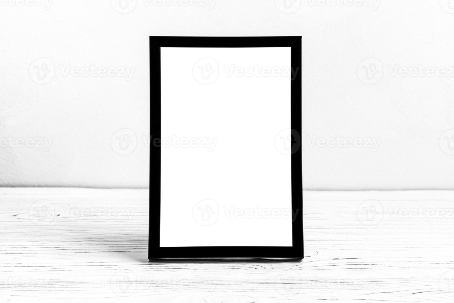 White wooden floor over concrete or decorative plaster wall and black photo frame with copy space for a text background. Mock up.