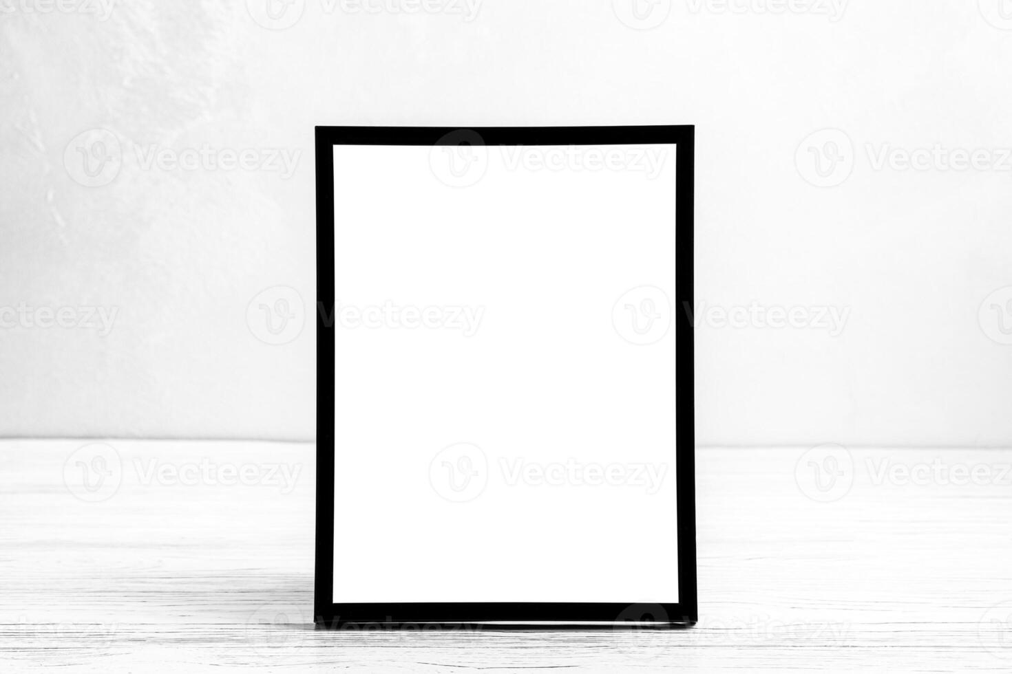 White wooden floor over concrete or decorative plaster wall and black photo frame with copy space for a text background. Mock up.
