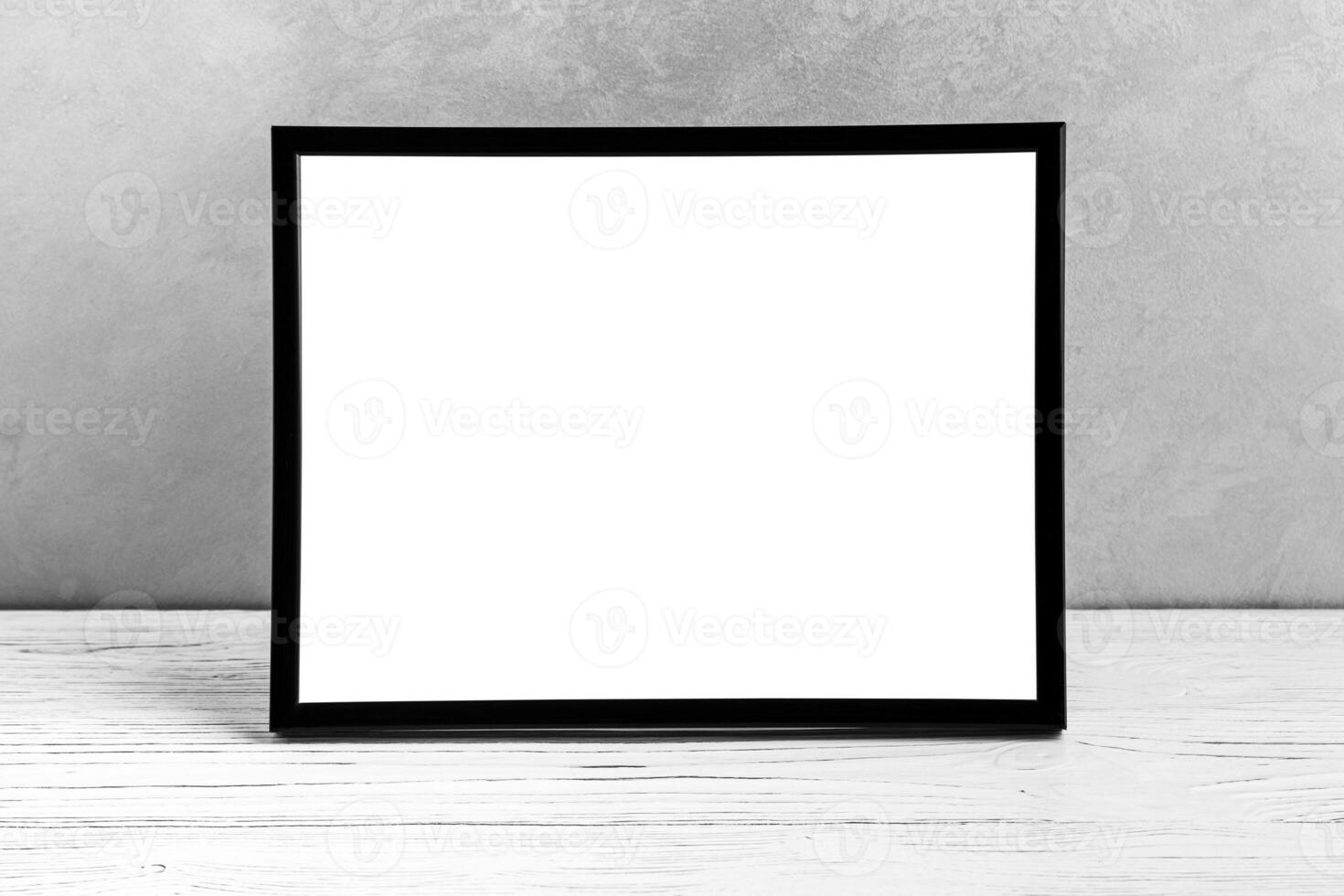 White wooden floor over concrete or decorative plaster wall and black photo frame with copy space for a text background. Mock up.