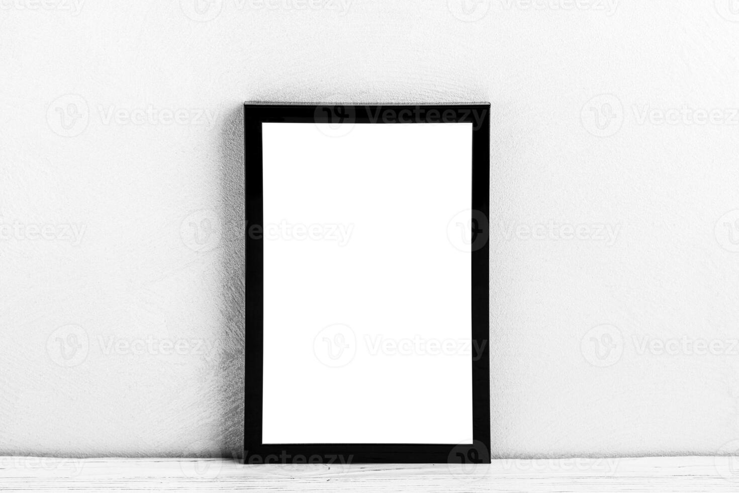 White wooden floor over concrete or decorative plaster wall and black photo frame with copy space for a text background. Mock up.