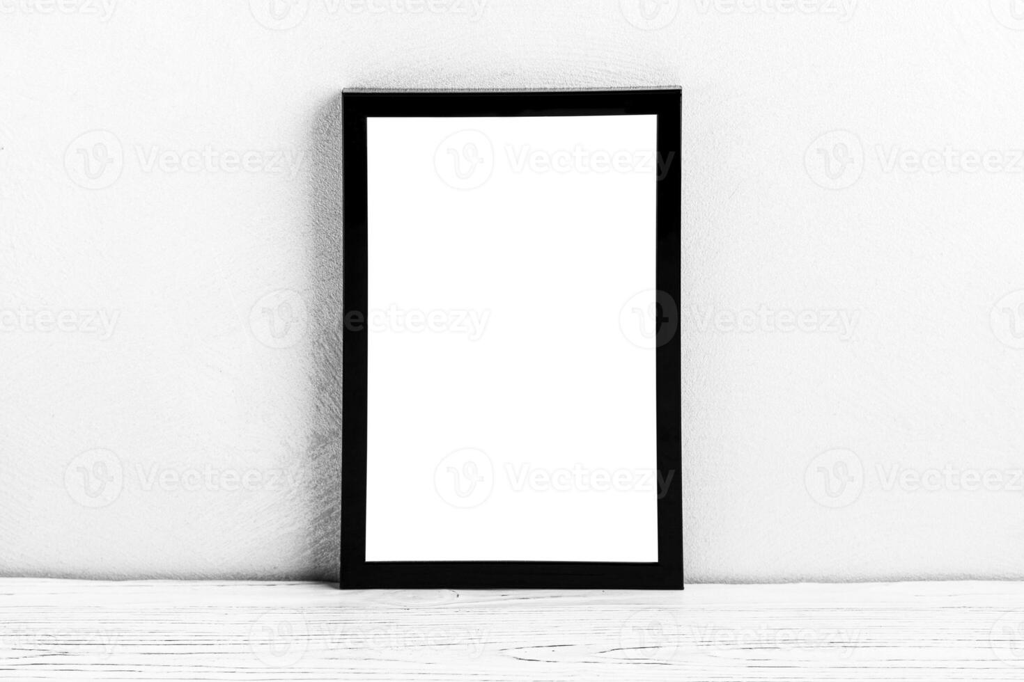 White wooden floor over concrete or decorative plaster wall and black photo frame with copy space for a text background. Mock up.