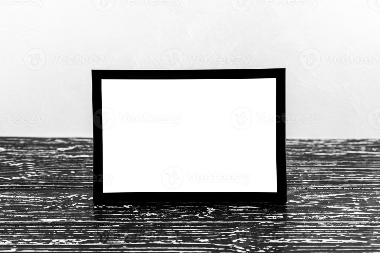 Wooden floor over concrete or decorative plaster wall and black photo frame with copy space for a text background. Mock up.
