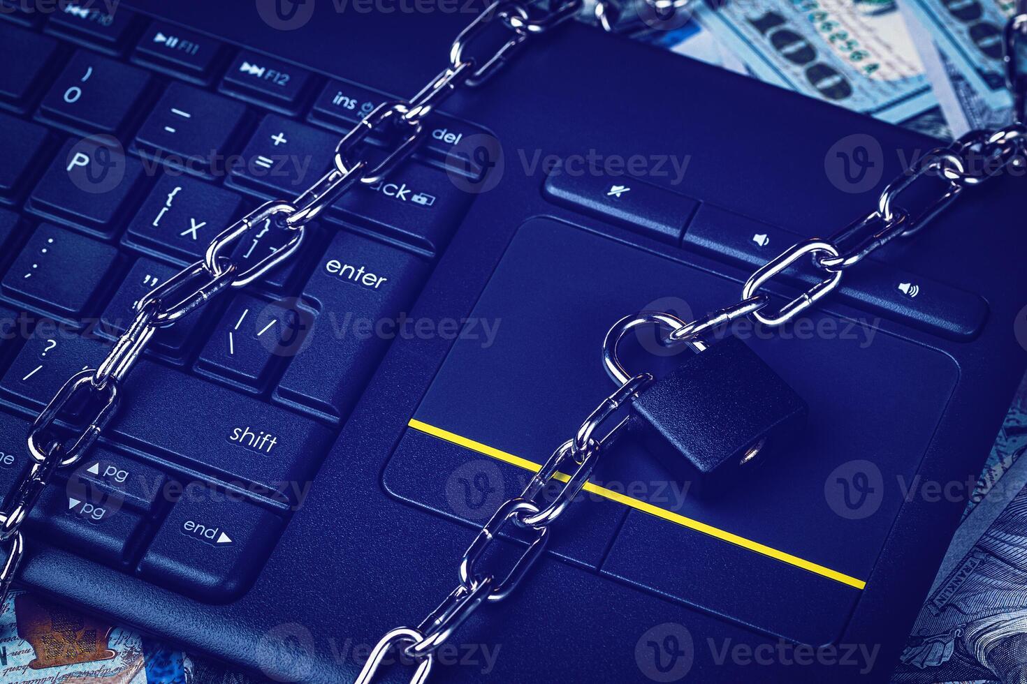 Dollar bills, black keyword and metal chain with lock. The concept of online trading, mining and commerce. Block or ban electronic money or e-business. photo