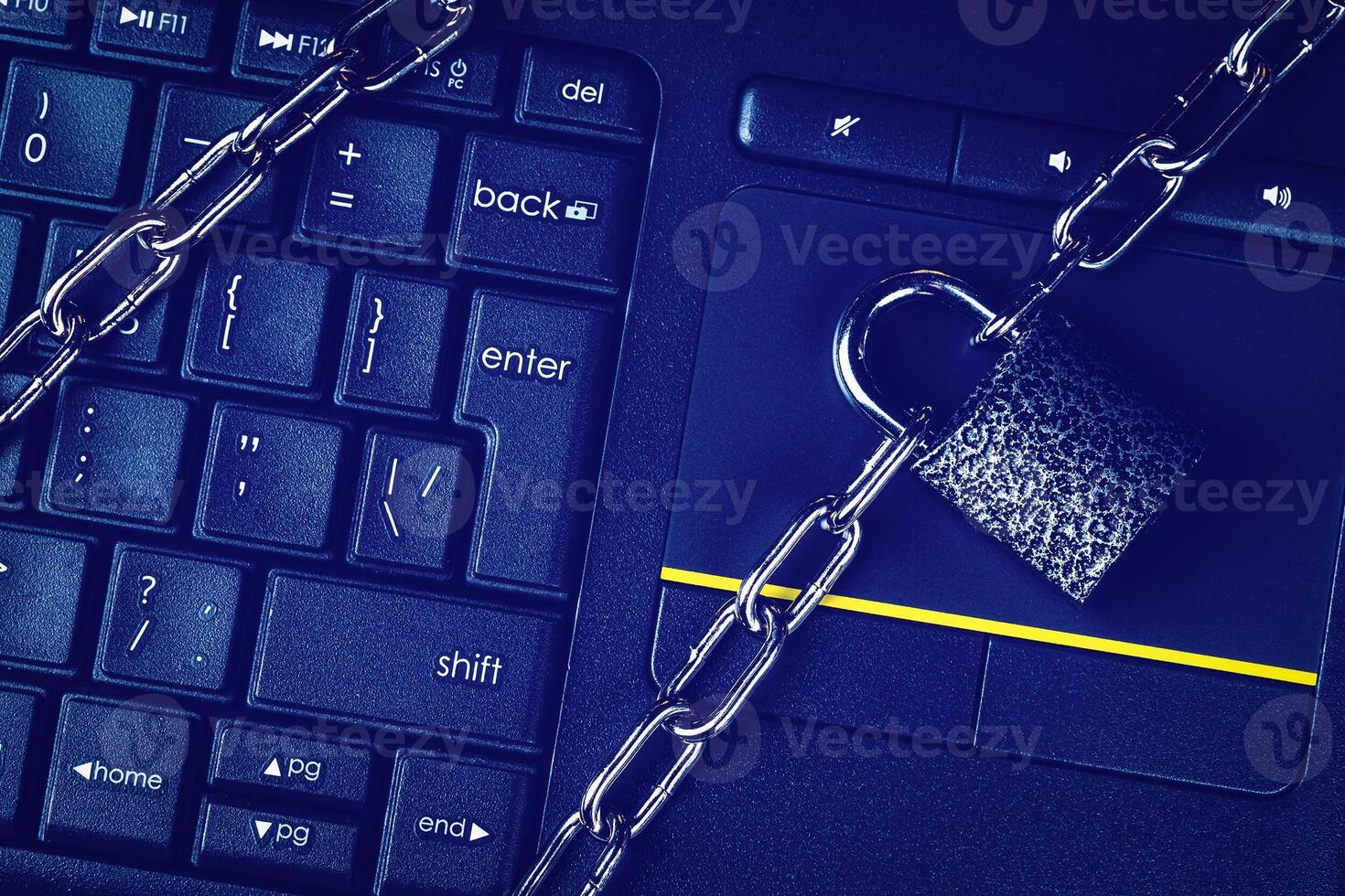 Black keyword and metal chain with lock. The concept of blocking or ban electronic money, e-business, mining, gaming or internet. Computer security or data protection. photo