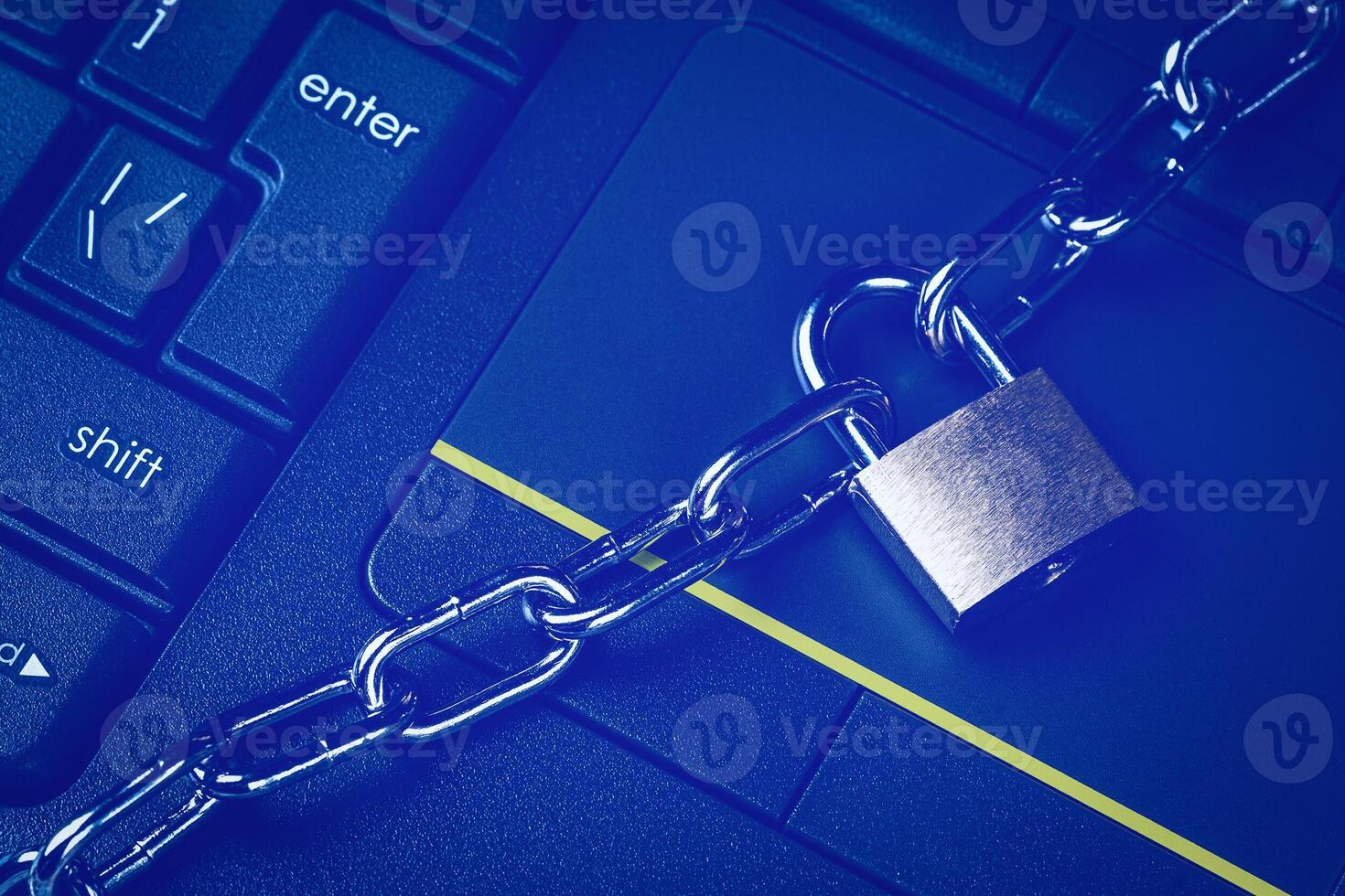 Black keyword and metal chain with lock. The concept of blocking or ban electronic money, e-business, mining, gaming or internet. Computer security or data protection. photo