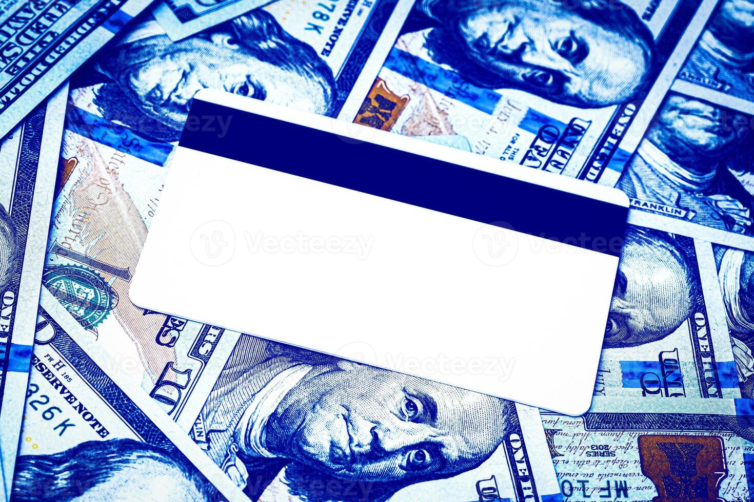 Dollar bills and white debit card with copy space for a text. The concept of electronic money and commerce. The concept of buying things on credit. Background or mock up for design. photo