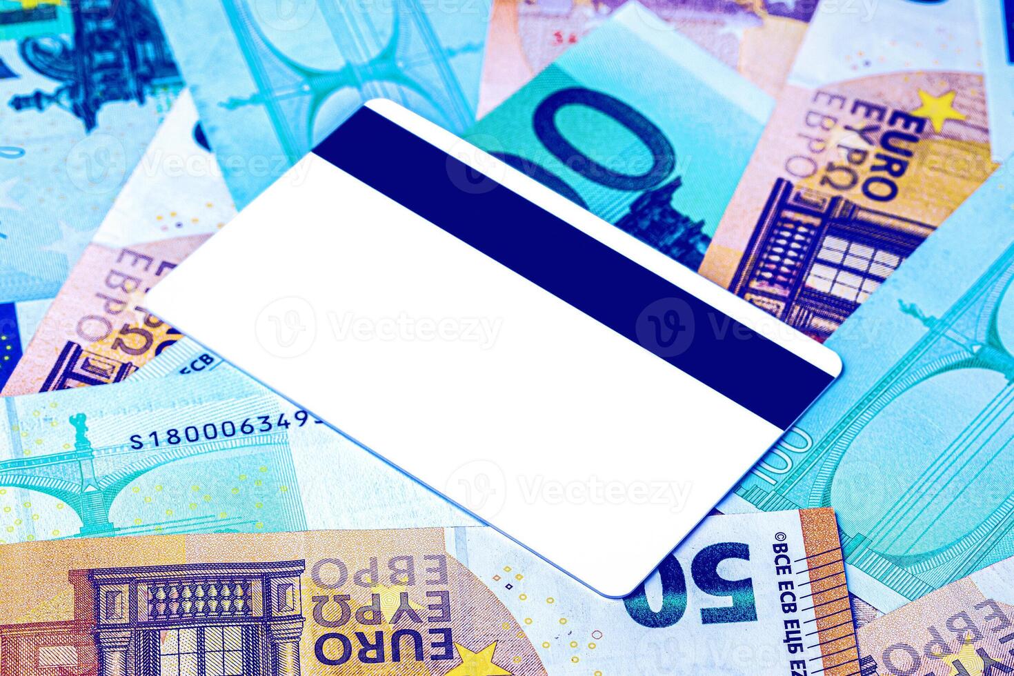 Euro bills and white debit card with copy space for a text. The concept of electronic money and commerce. The concept of buying things on credit. Background or mock up for design. photo