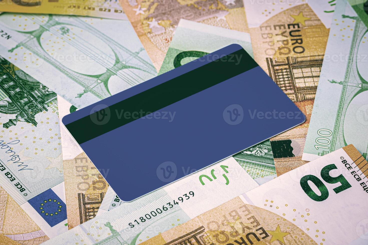 Euro bills and blue debit card with copy space for a text. The concept of electronic money and commerce. The concept of buying things on credit. Background or mock up for design. photo