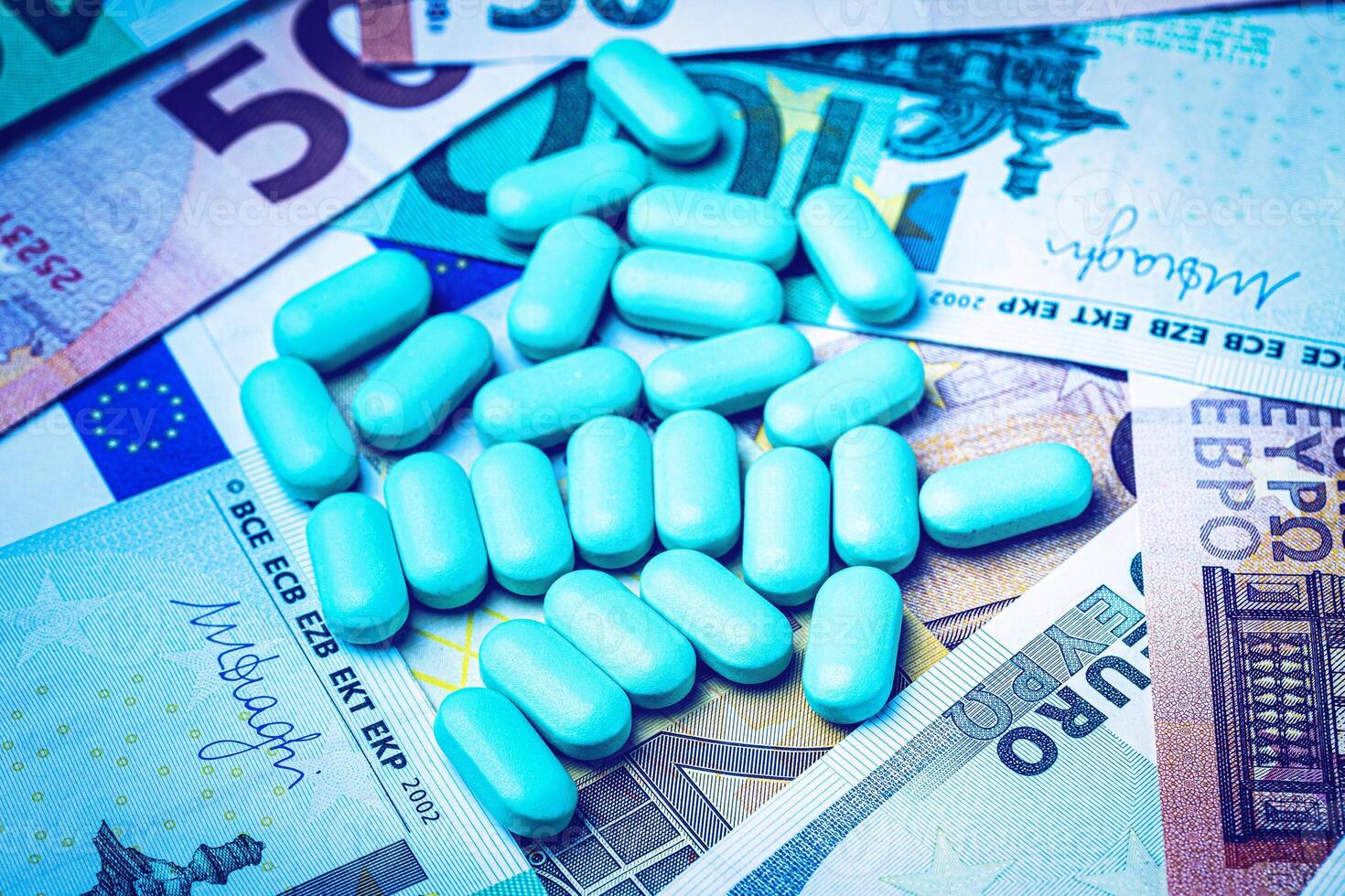 Green pills on the background of euro bills. The concept of the expensive cost of healthcare or financing medicine. photo