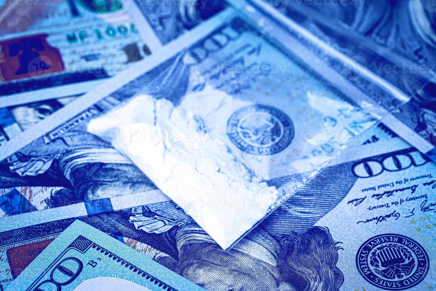 A bag with white narcotic powder like heroin or cocaine on the background of one hundred dollar bills. The concept of the use and sale of drugs. photo