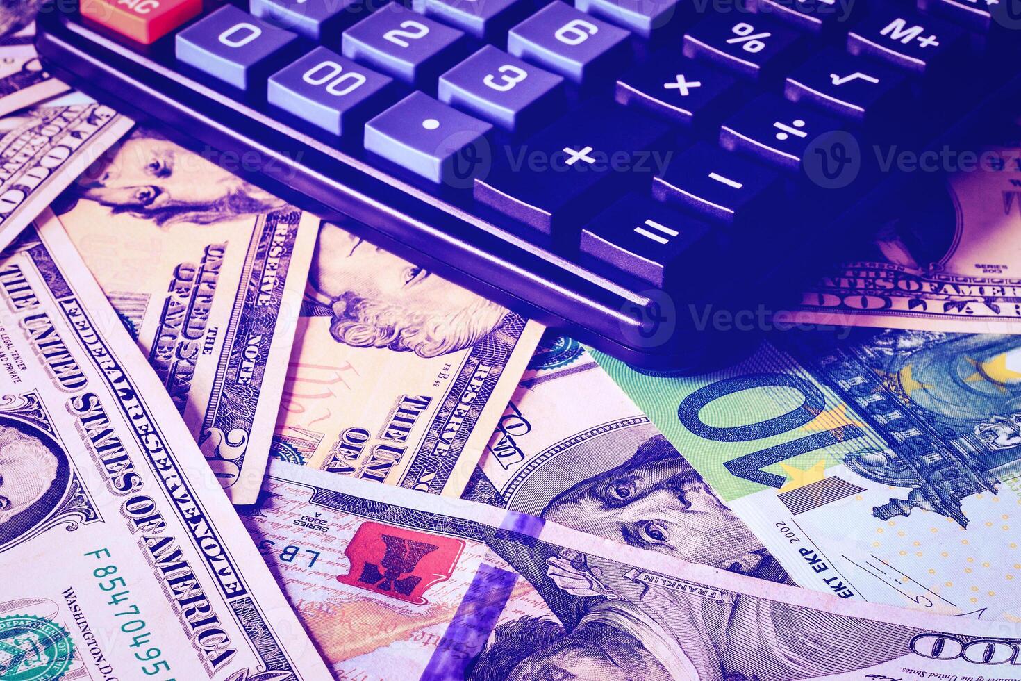 Dollar and euro bils and black calculator. photo