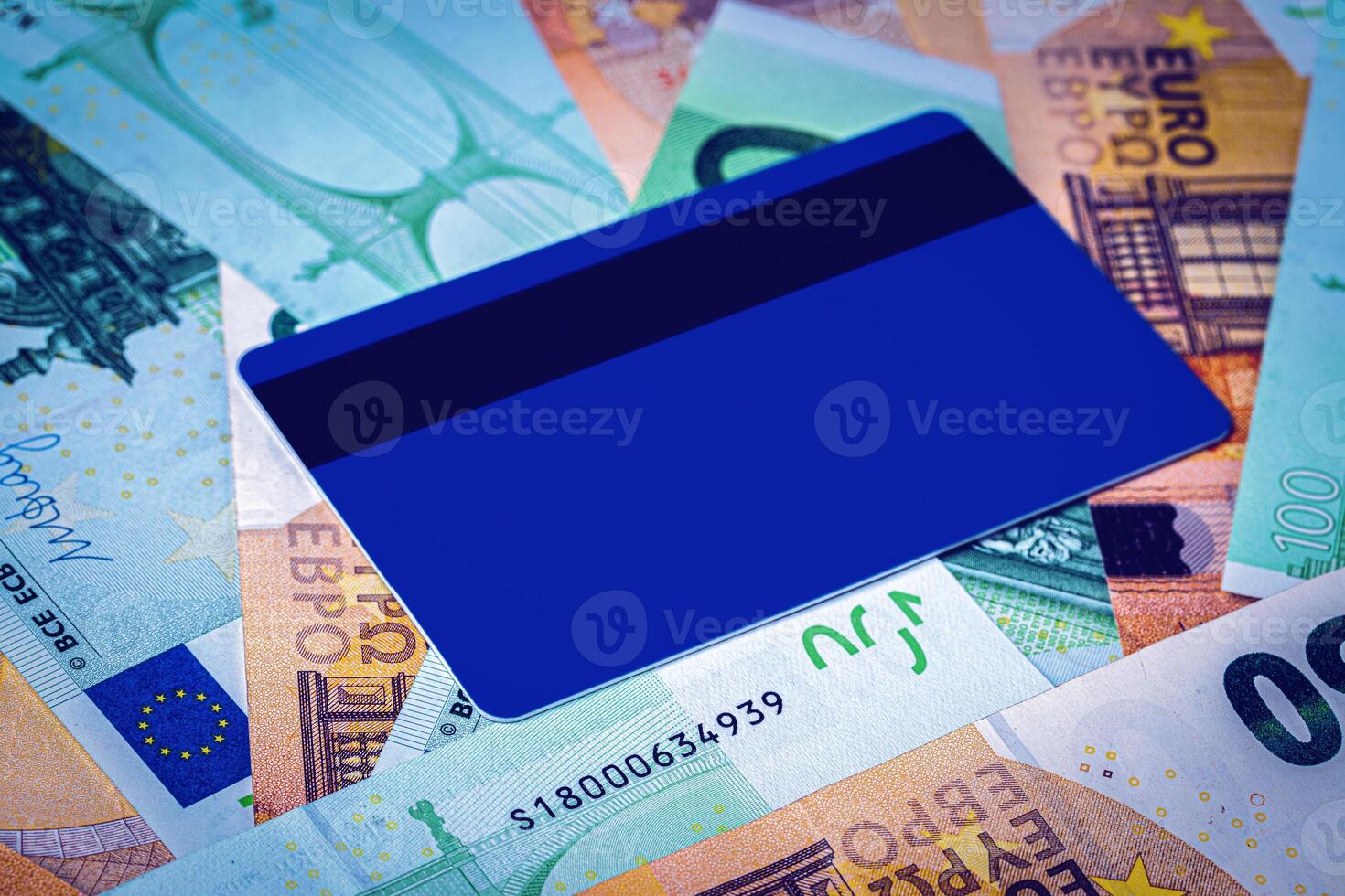 Euro bills and blue debit card with copy space for a text. The concept of electronic money and commerce. The concept of buying things on credit. Background or mock up for design. photo