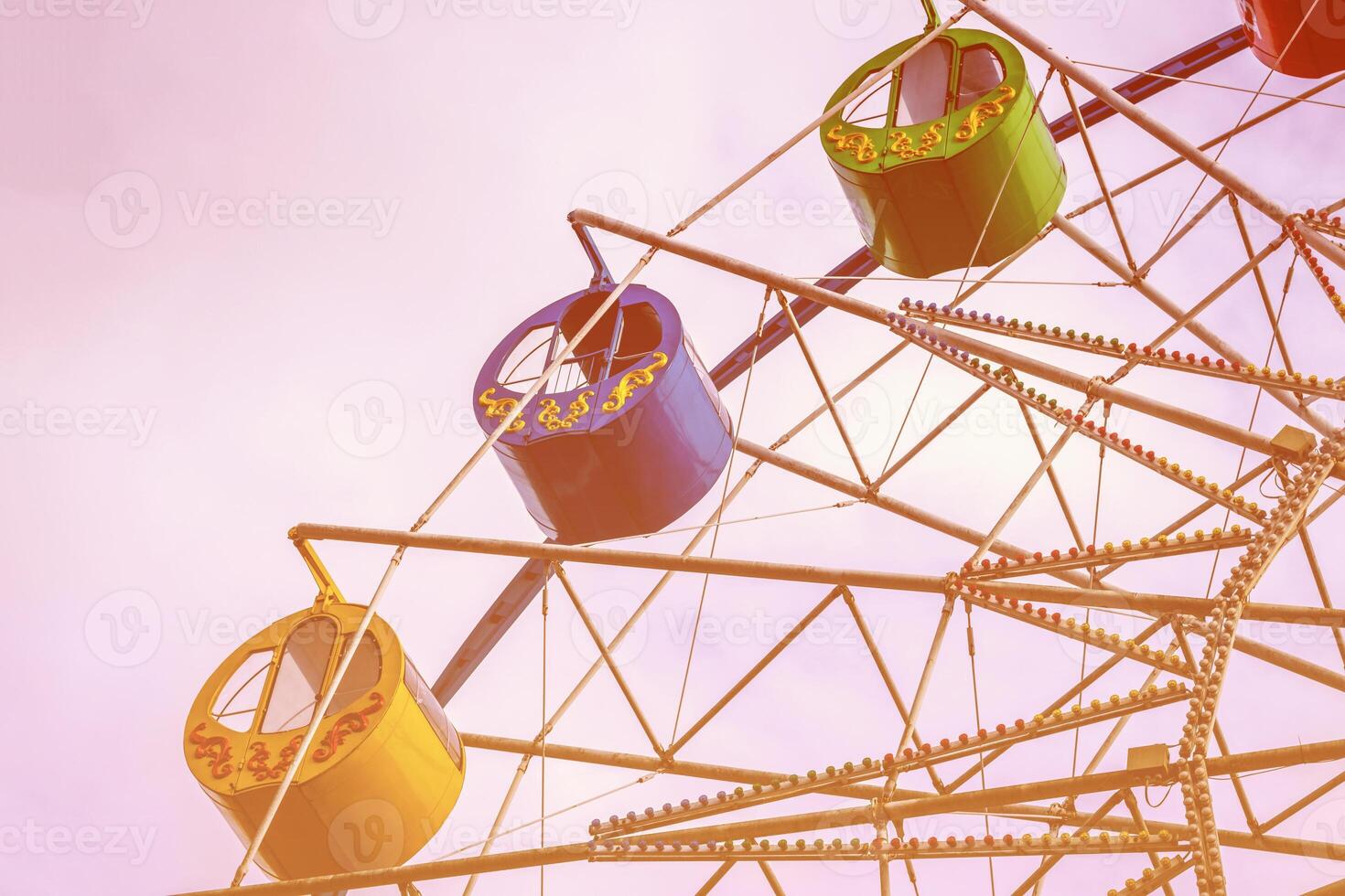Ferris wheel with colorful cabs against the sky. photo