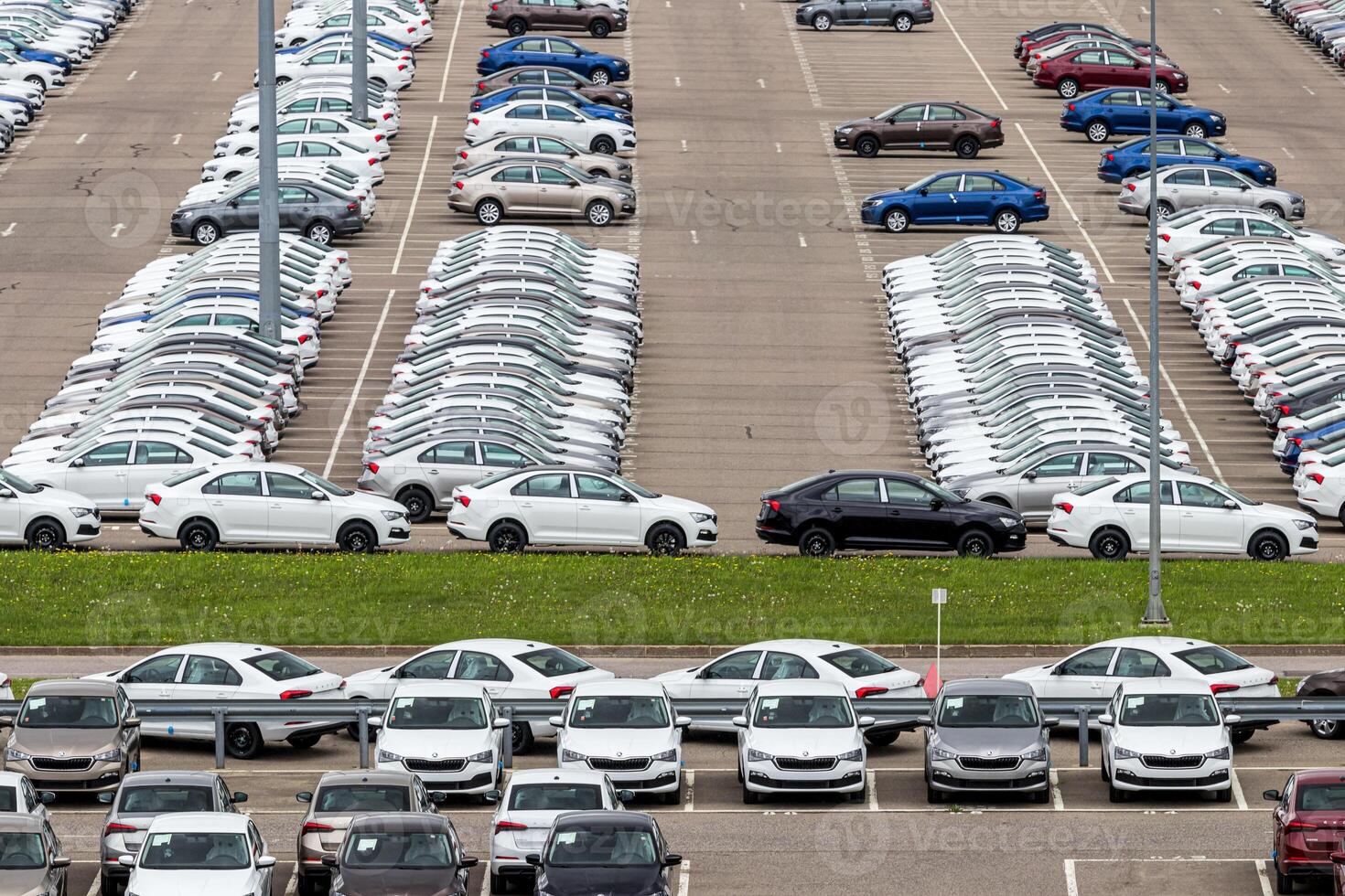 Volkswagen Group Rus, Russia, Kaluga - MAY 24, 2020 Rows of a new cars parked in a distribution center. Top view to the parking in the open air. photo